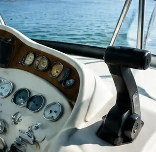 A boat control panel with a black knob and a white background.