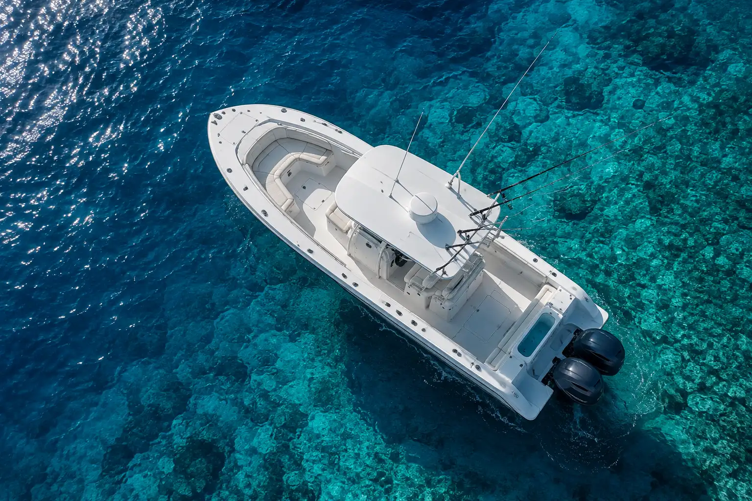 A white boat with a blue hull in the ocean.